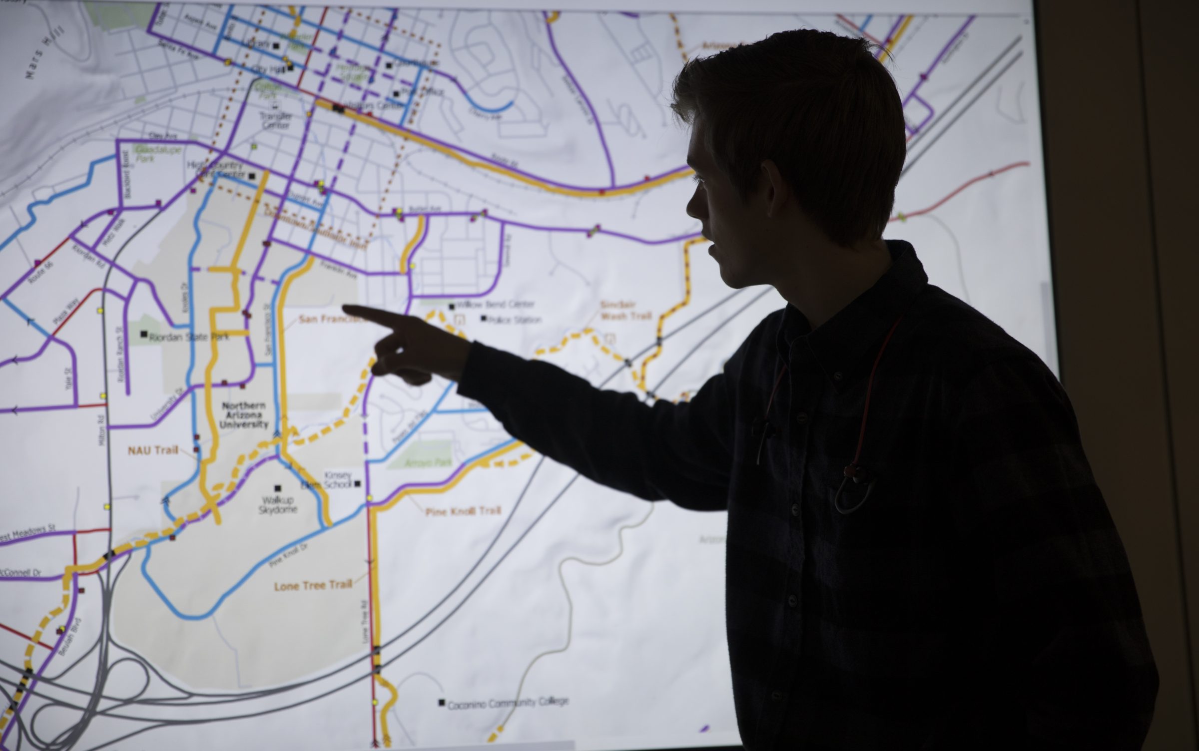 Student pointing on a map.