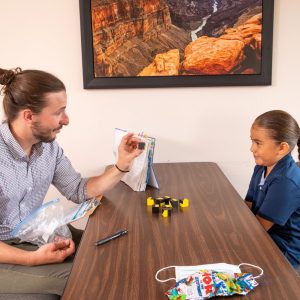 Faculty teaching a young student.