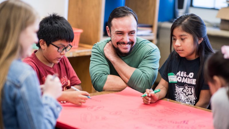 Student teacher working with young students.