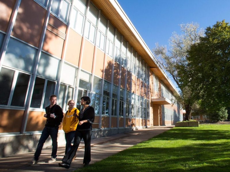 Student and professor walking together on campus.