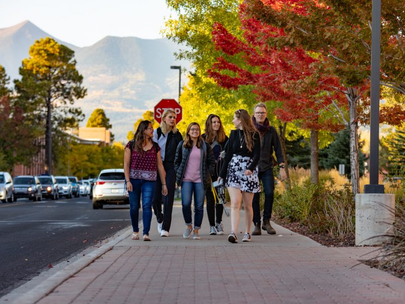 Group of students walking together on campus.
