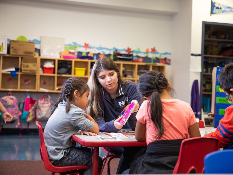 N A U student teacher reads to child.