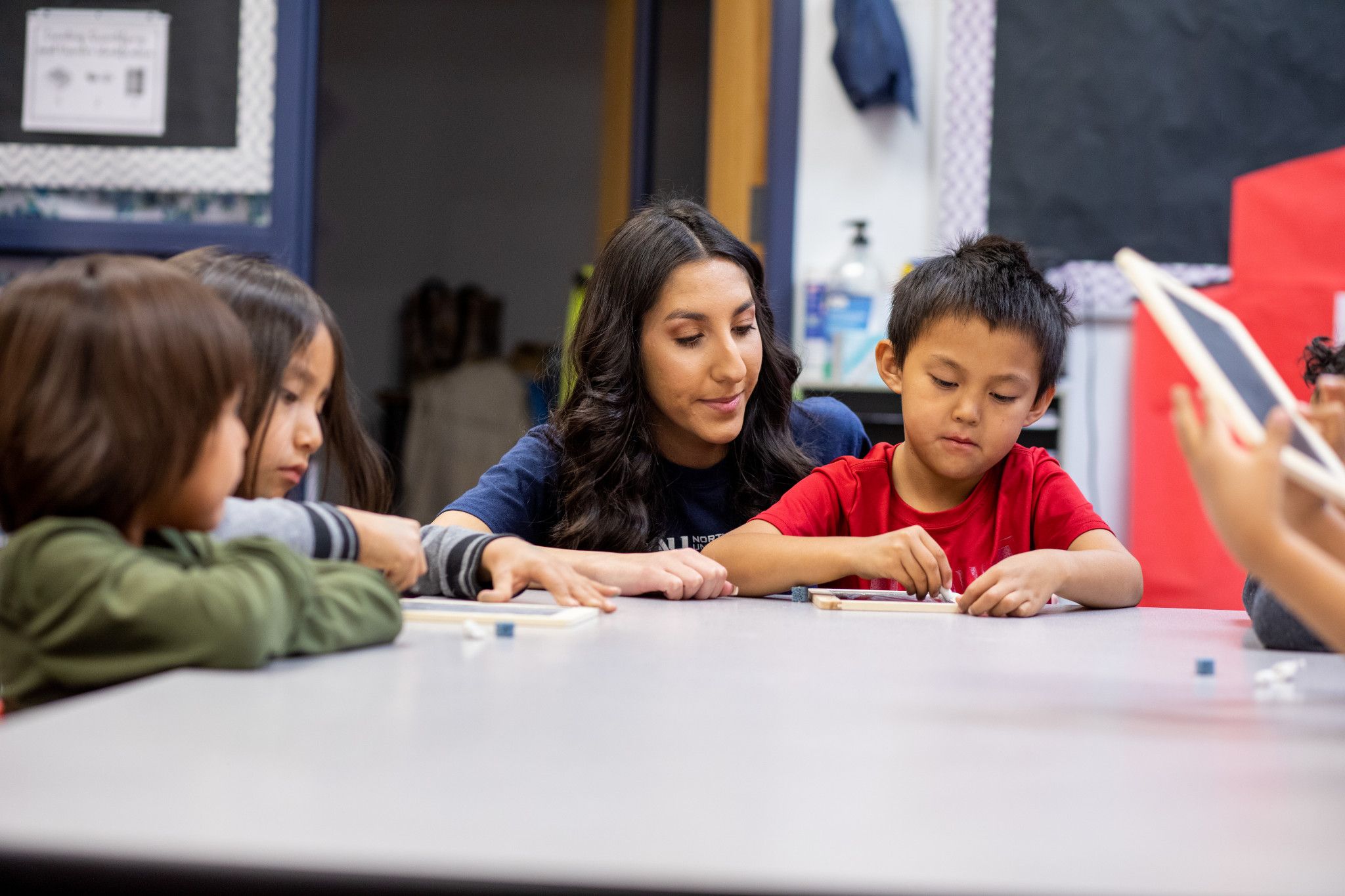 N A U student teacher helps child with project.
