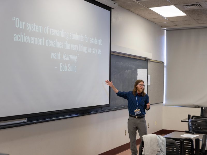 Professor teaching a class with a presentation.