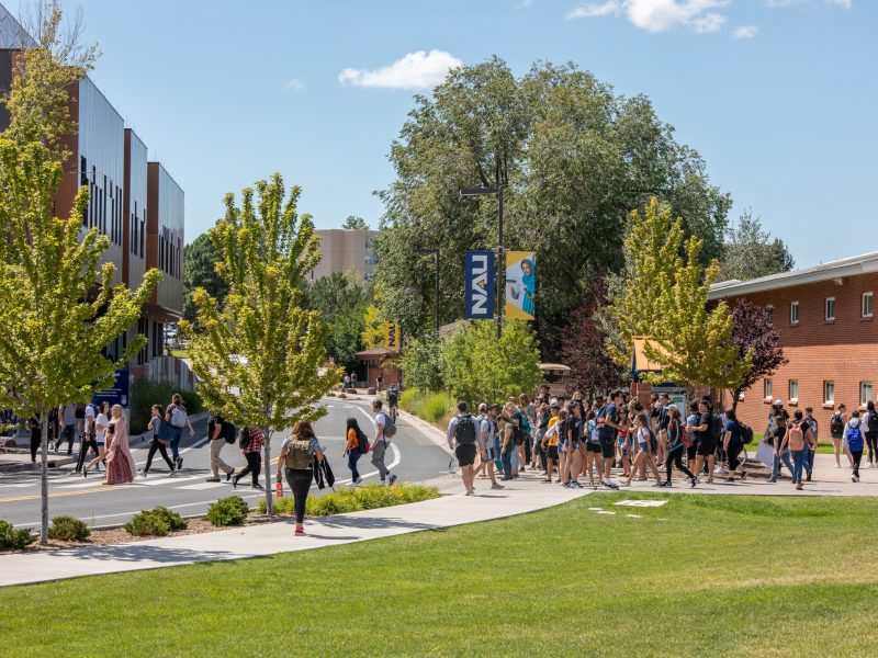 N A U students walking outside on campus.