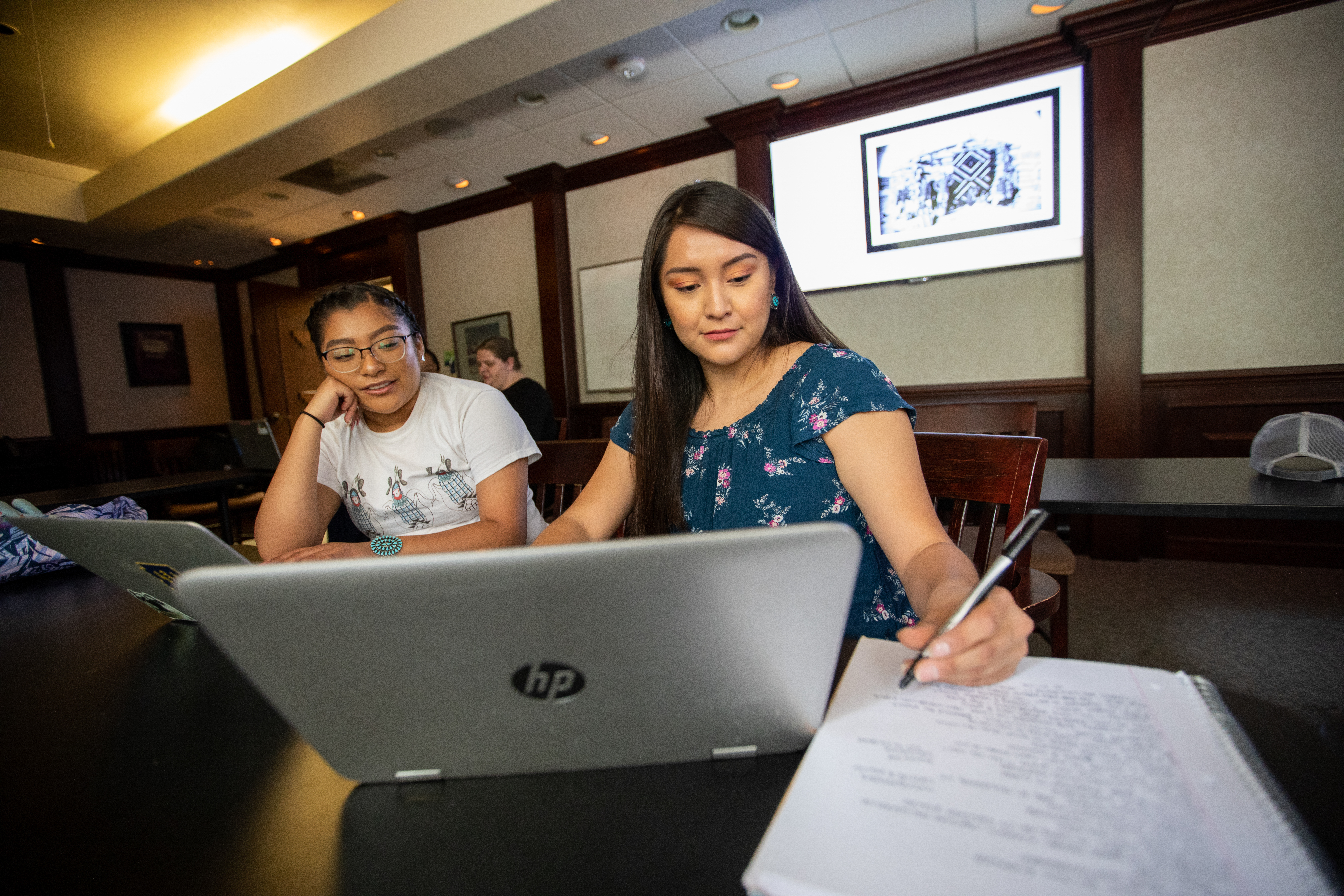 Two students working together in classroom.