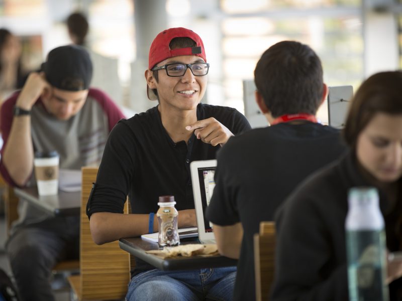 Students sitting at the cafeteria.