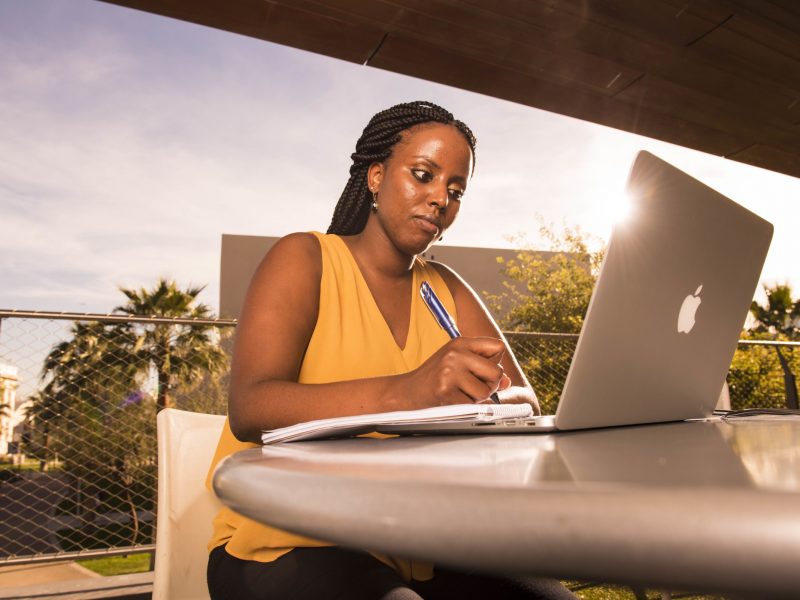 Student working on a computer outside.