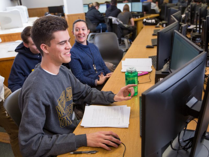 A photo of students working on computers in a classroom.