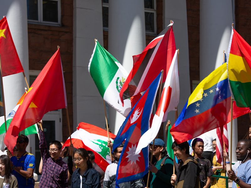 A photo of several international flags held up in the air