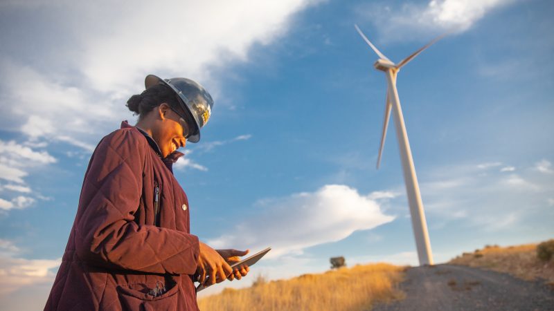 A student observing a report at a wind farm.