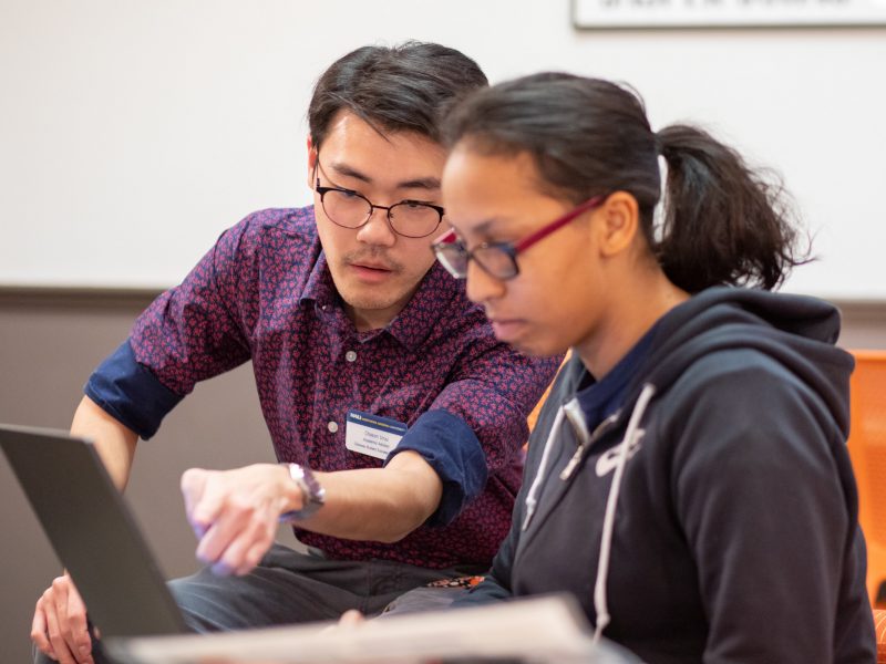 A photo of a counselor helping a student.