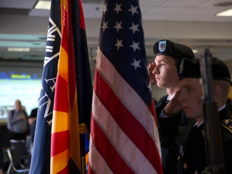 Students saluting the American flag.