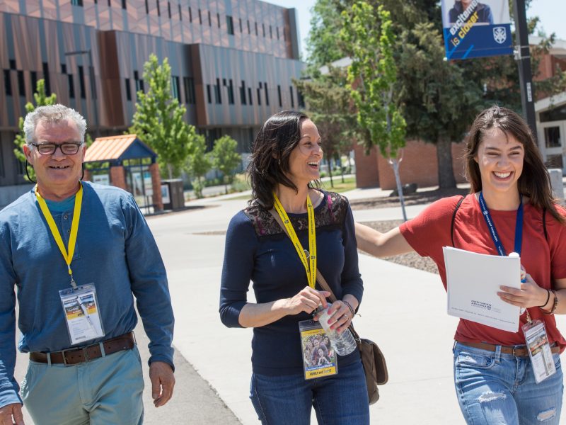 A family happily interacting on the N A U campus.