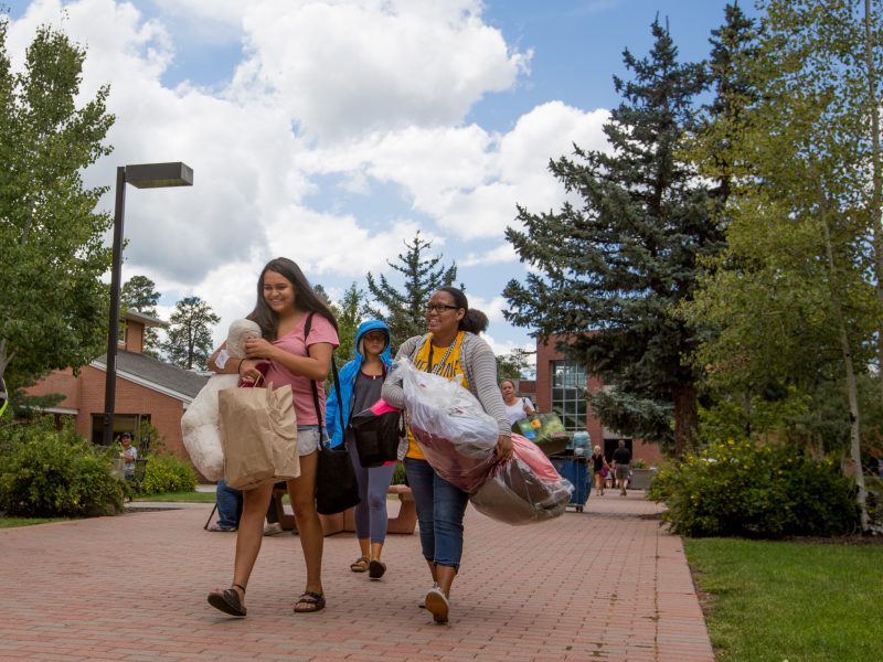 Students carry bags and packs during Move-In day at N A U Flagstaff campus.