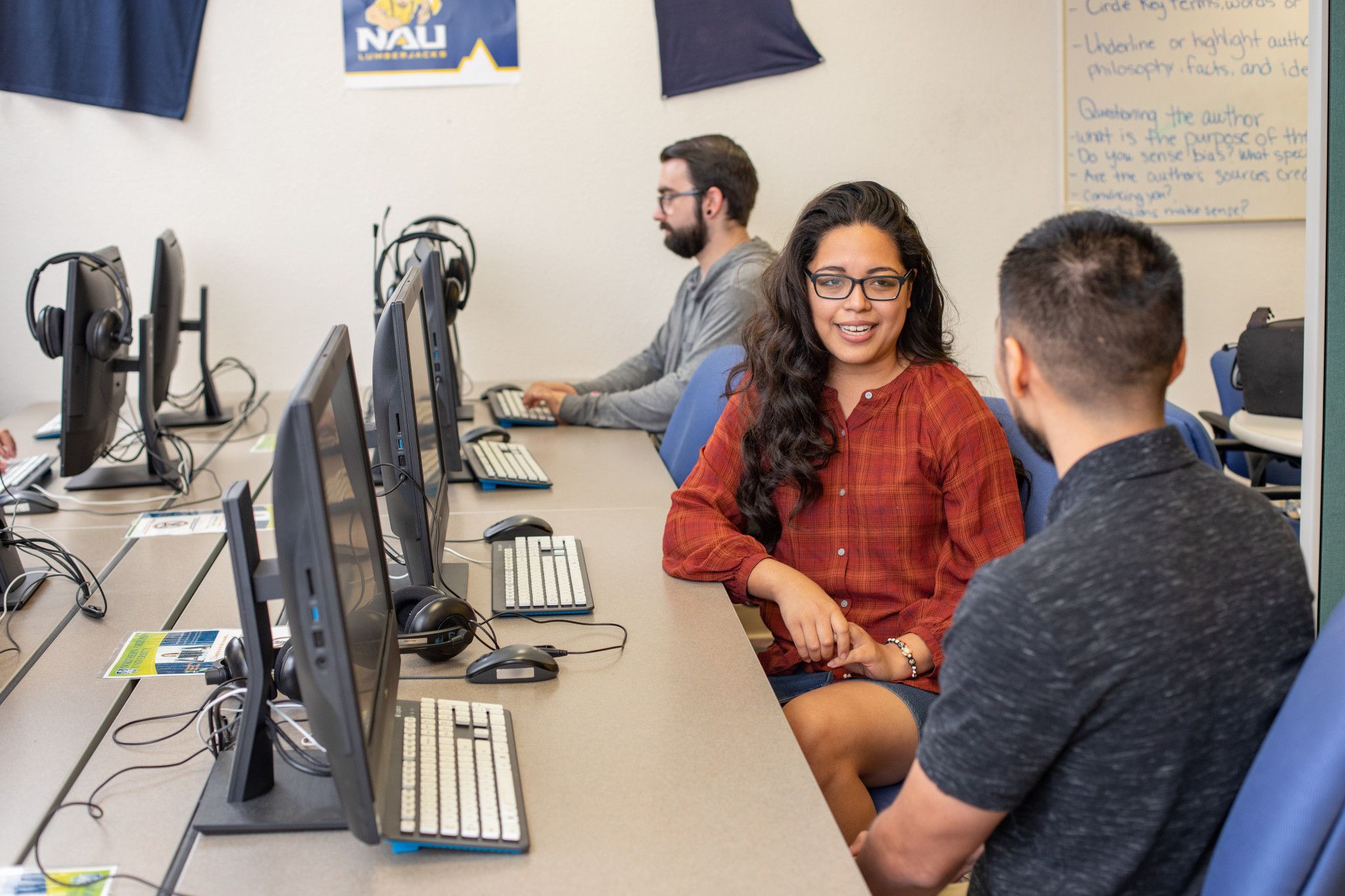 Yuma tutor talking with a student in a computer lab.