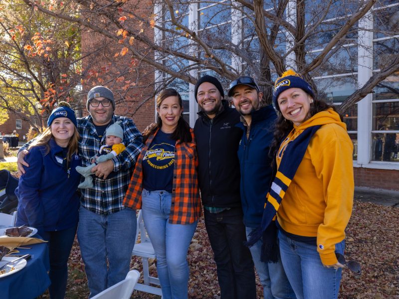 N A U alumni pose for a photo.