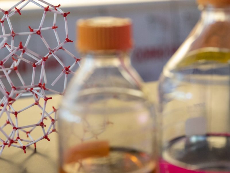 Molecular structure and liquids used in research labs.