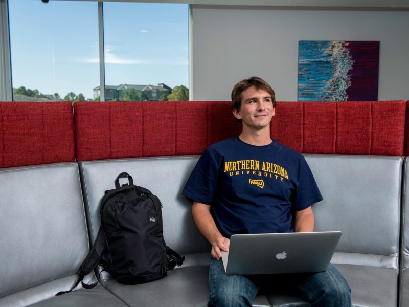 A student in the honors building on their computer.