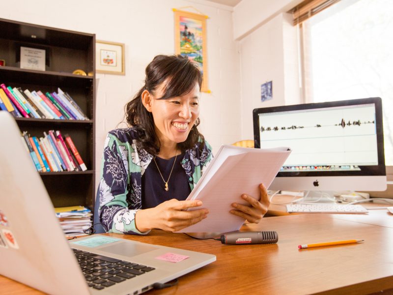 A photo of a professor looking at papers.