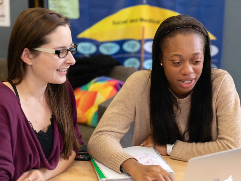 A student and tutor working at the writing commons.