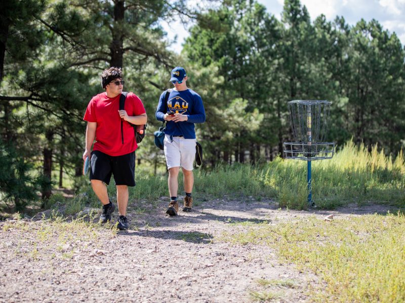 A photo of students walking on a trail.
