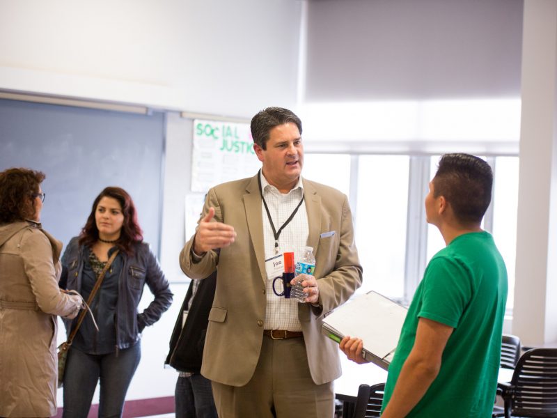 A photo of a professor speaking to a student.