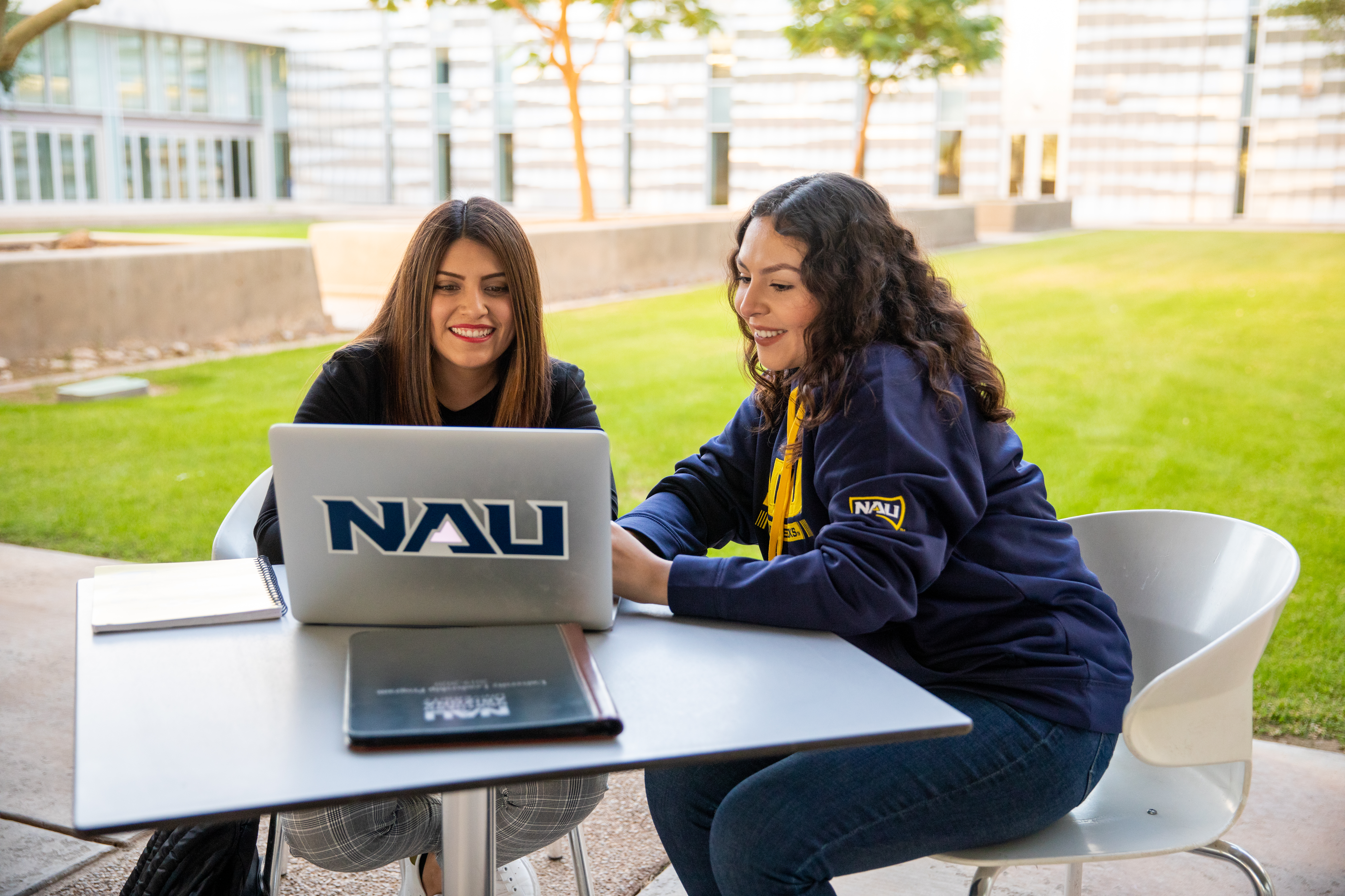 Students looking at laptop together.