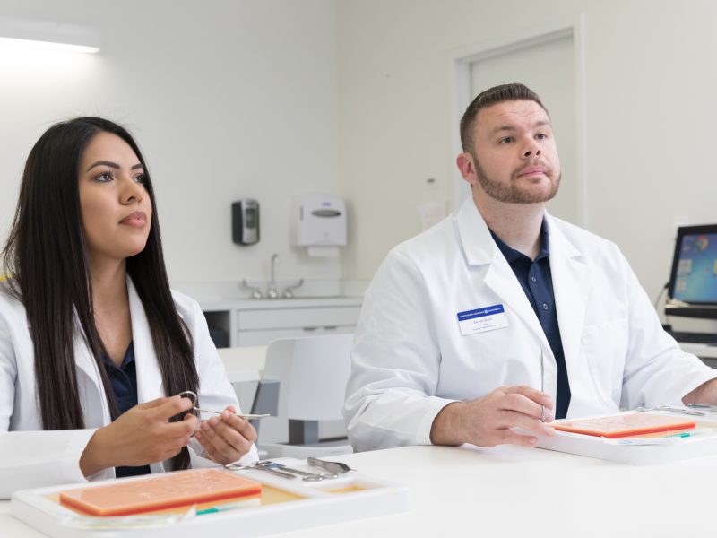 A photo of physician assistants working at a table.