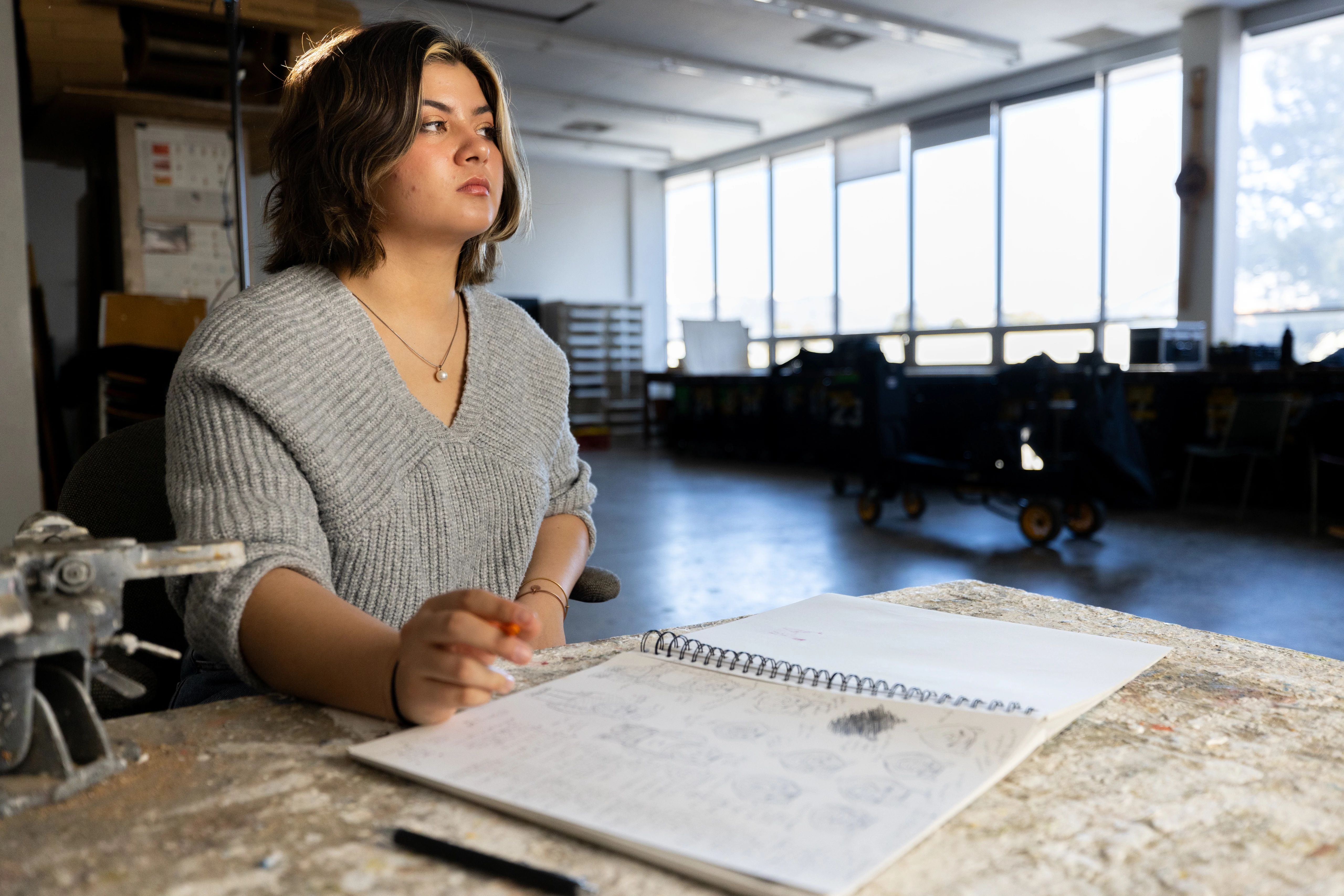 Student looking at the distance in a classroom.