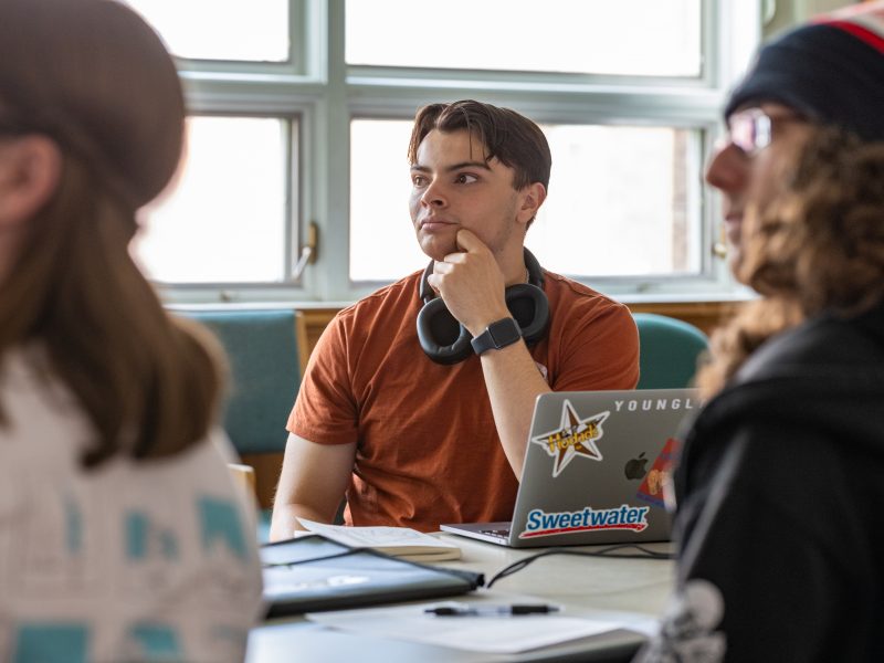 Student looking at lecture in classroom.
