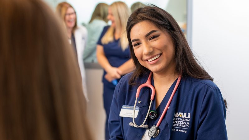 Nursing student talking to a patient.