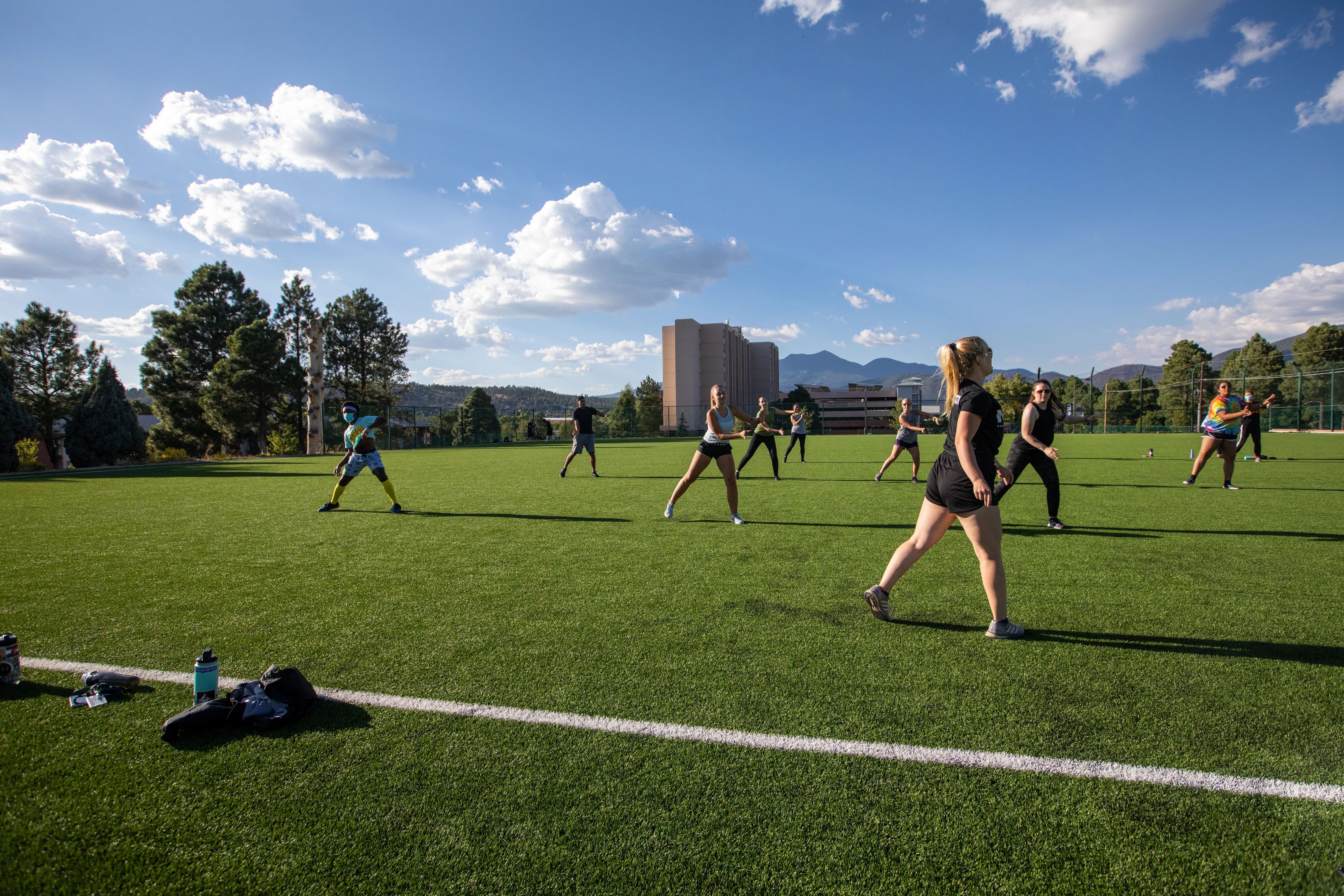 Outdoor group fitness class doing steps.