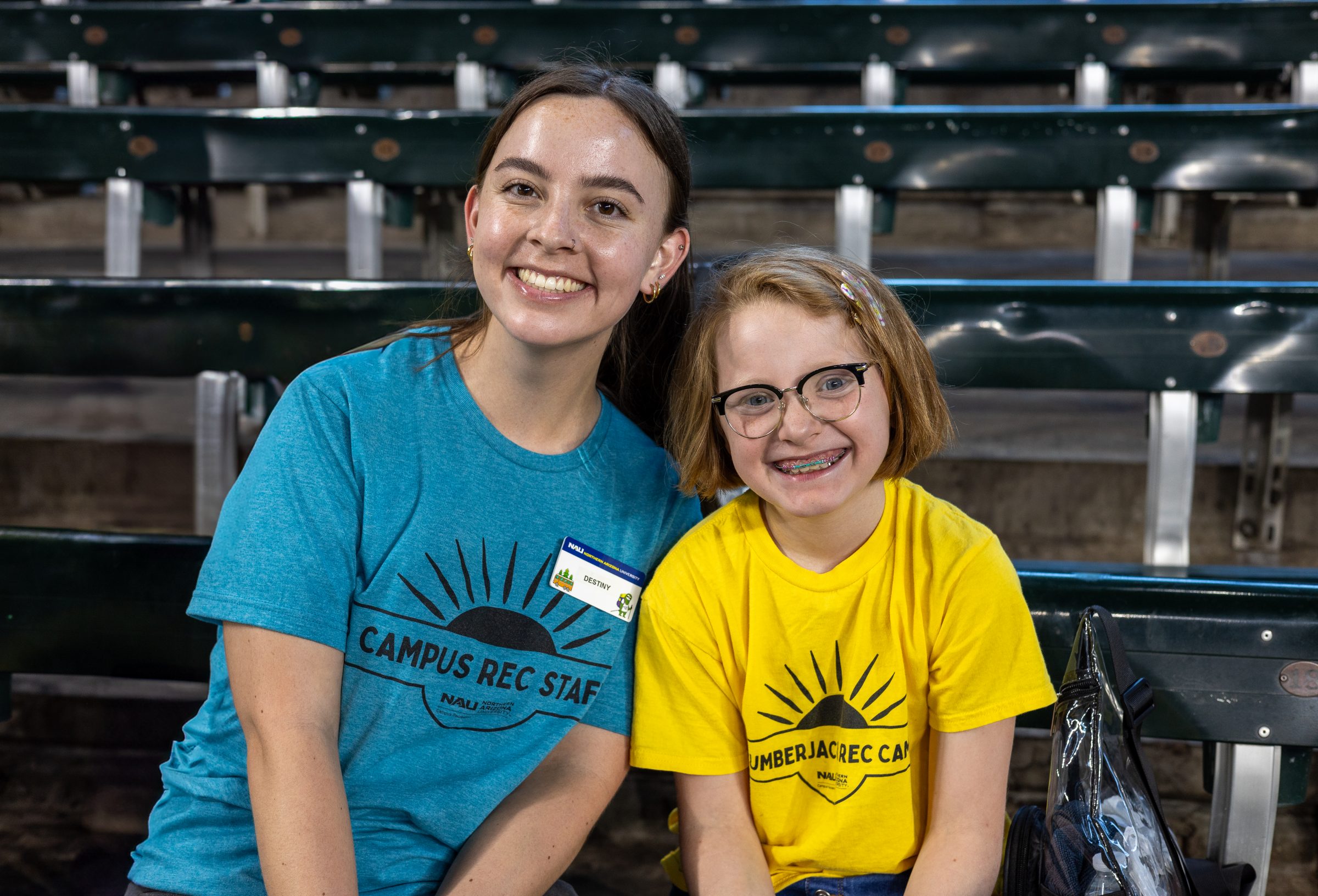 A counselor and camper sitting together at an Arizona Diamondbacks game.
