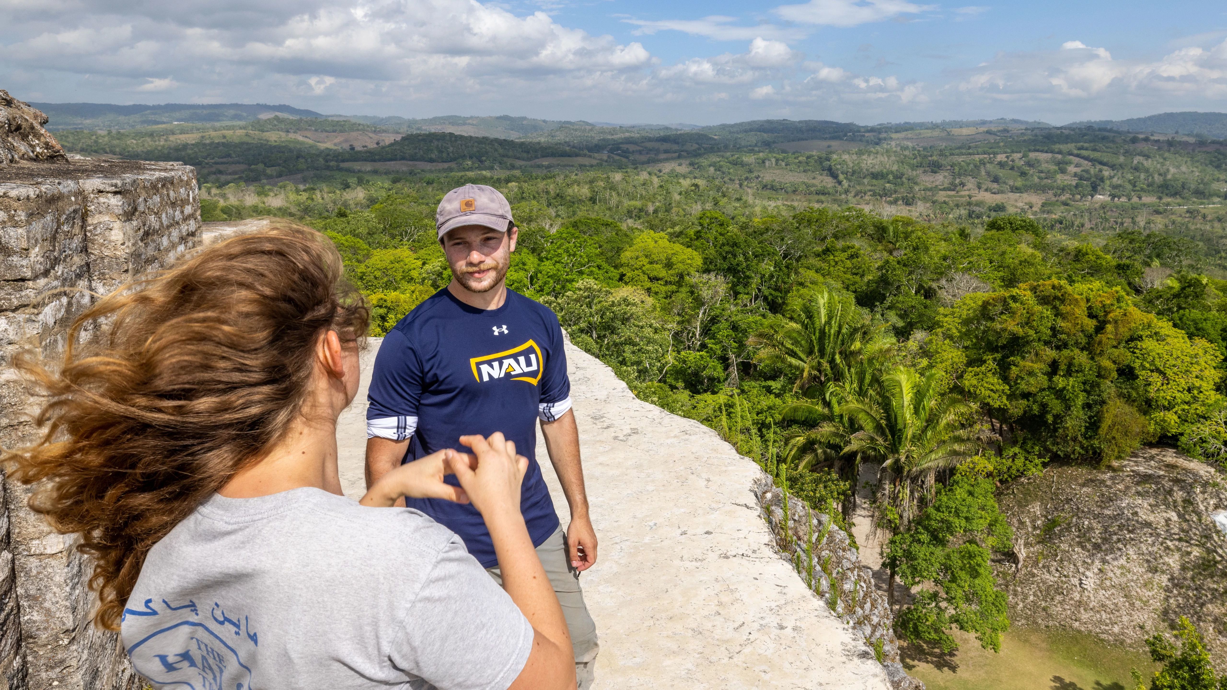 Two students standing front of a view.