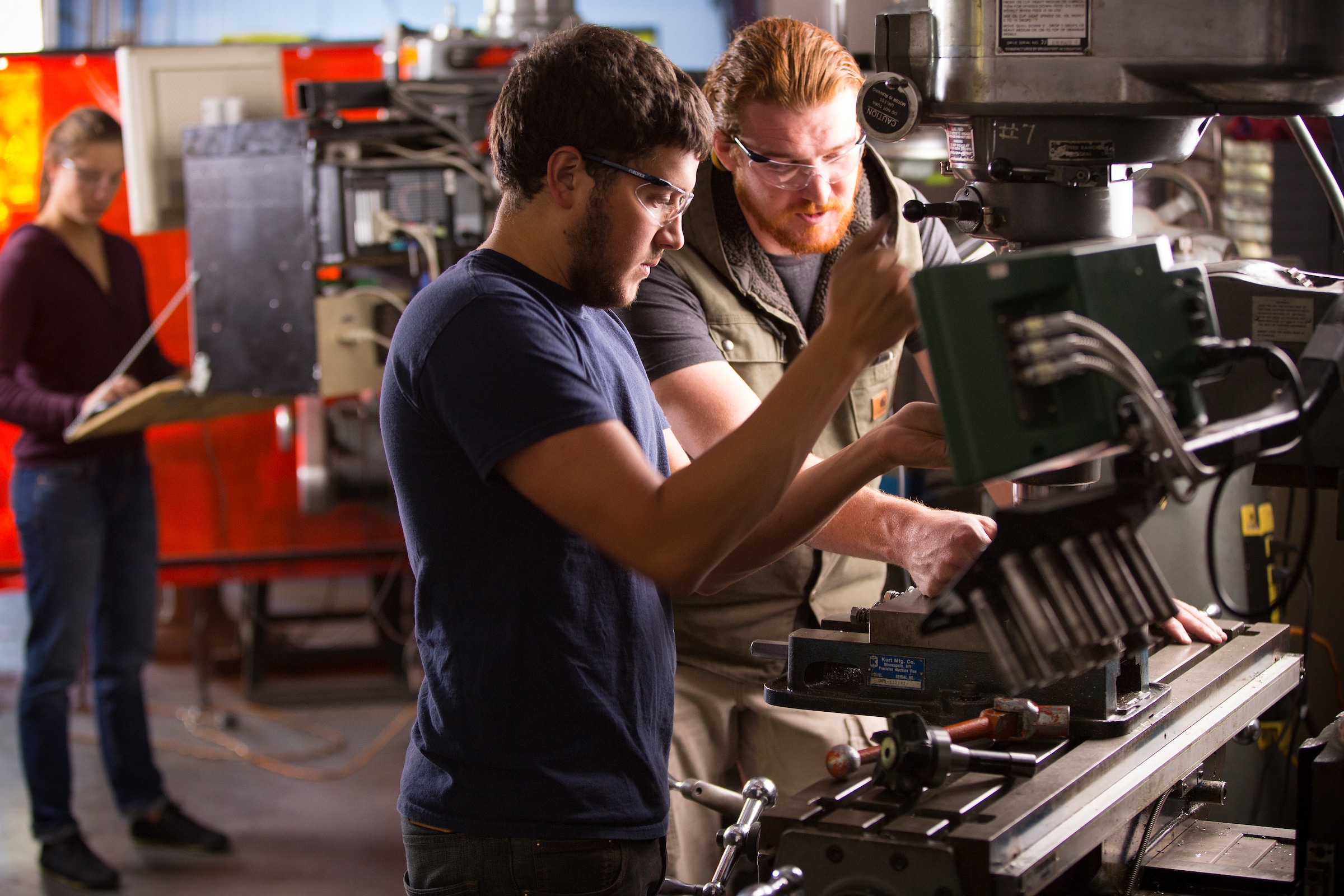N A U engineering students working with machinery.