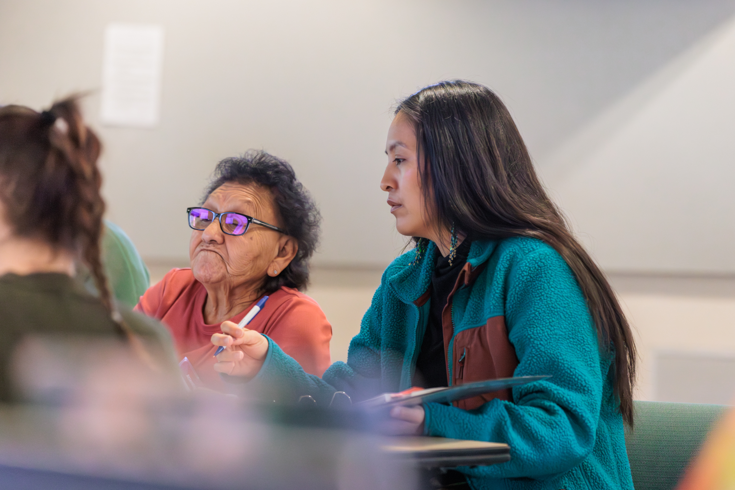 A student assisting an elder with a computer