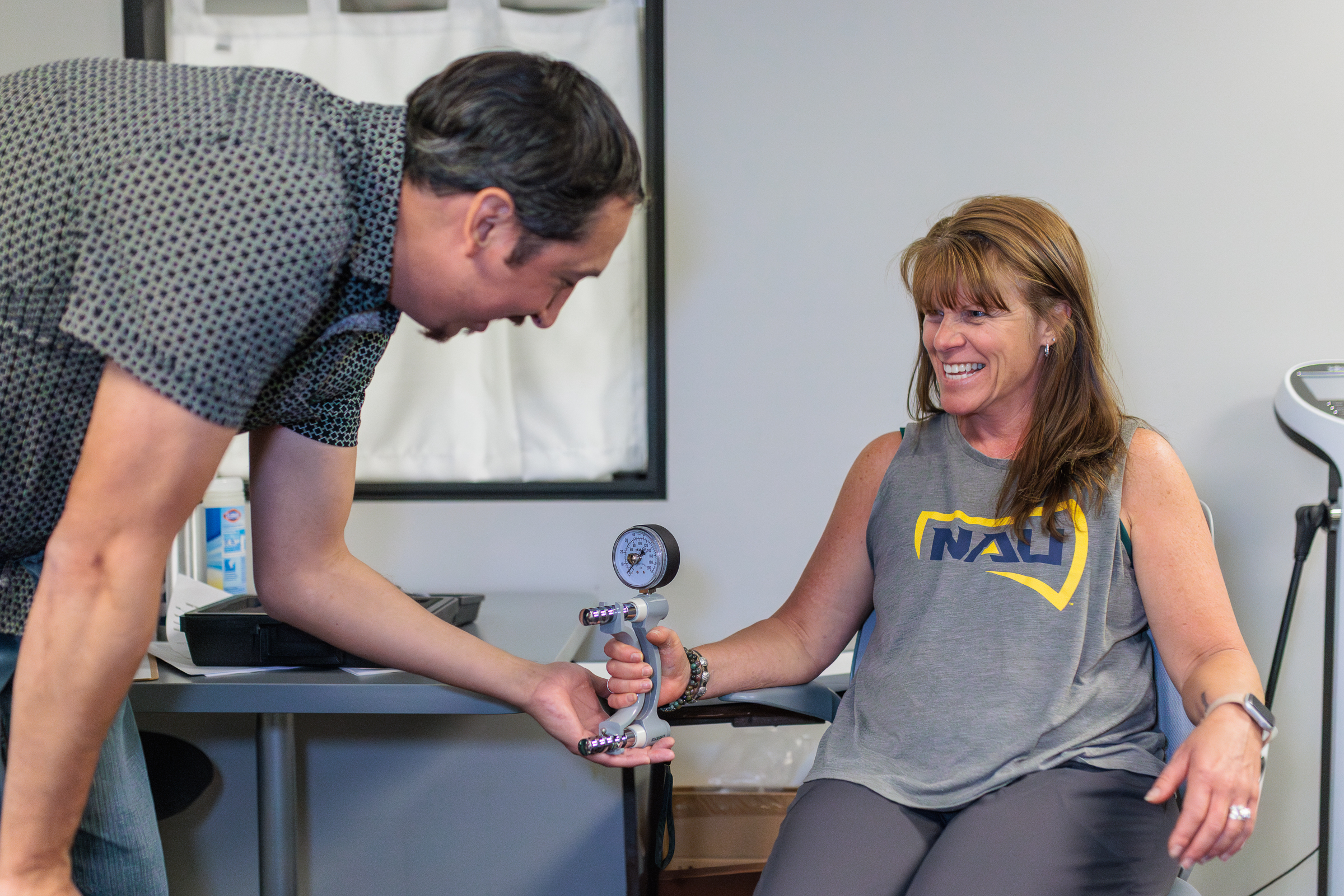 Michelle Cook and Travis Pinn testing the grip strength measuring device.