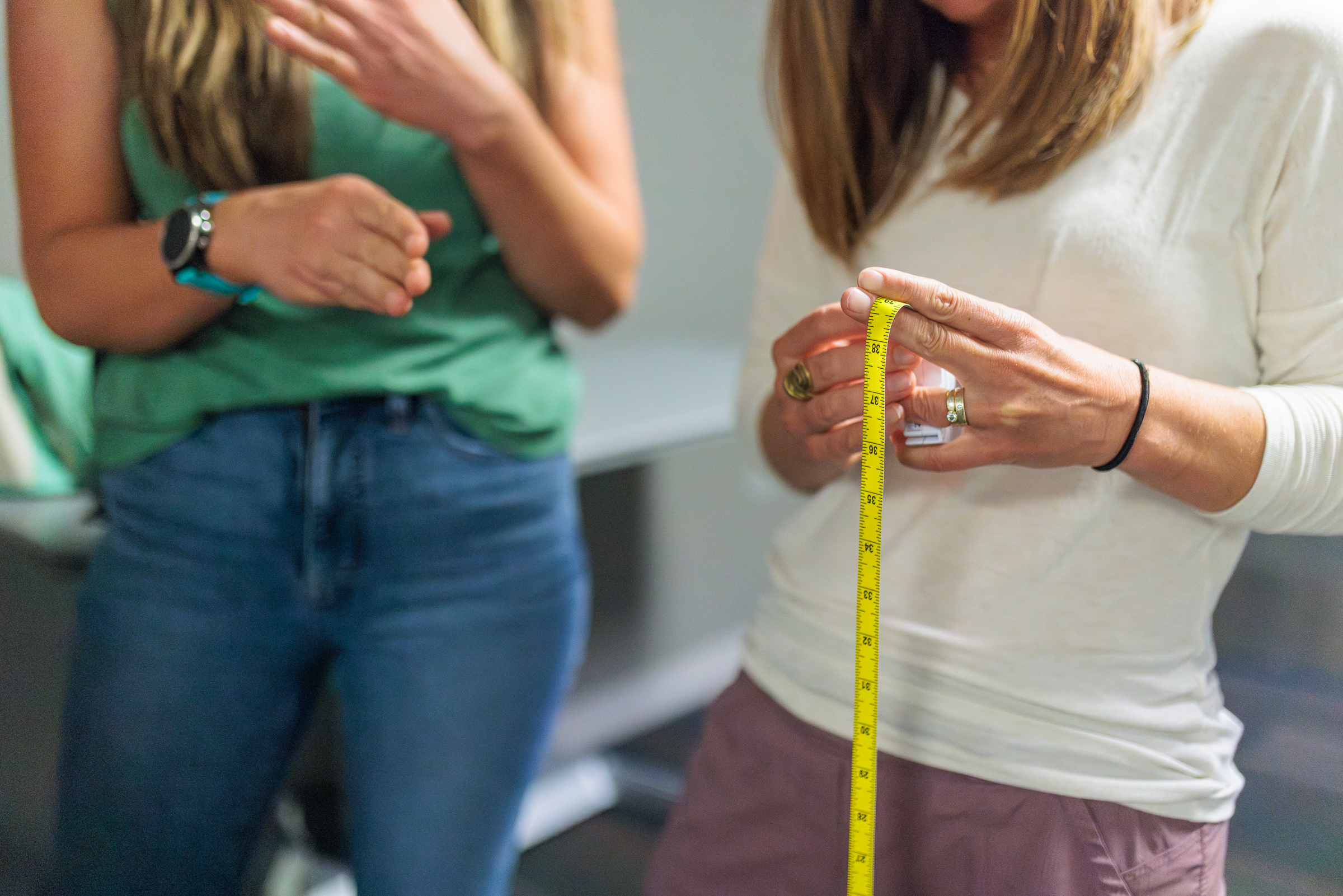 Project researchers look over the waist measuring device.