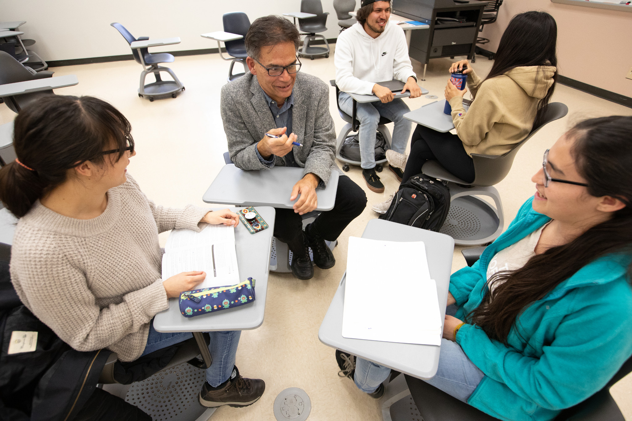 Dine college students in a classroom.