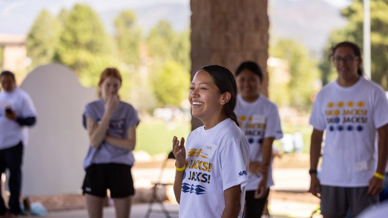 Students smiling outside in indigenous field day event.
