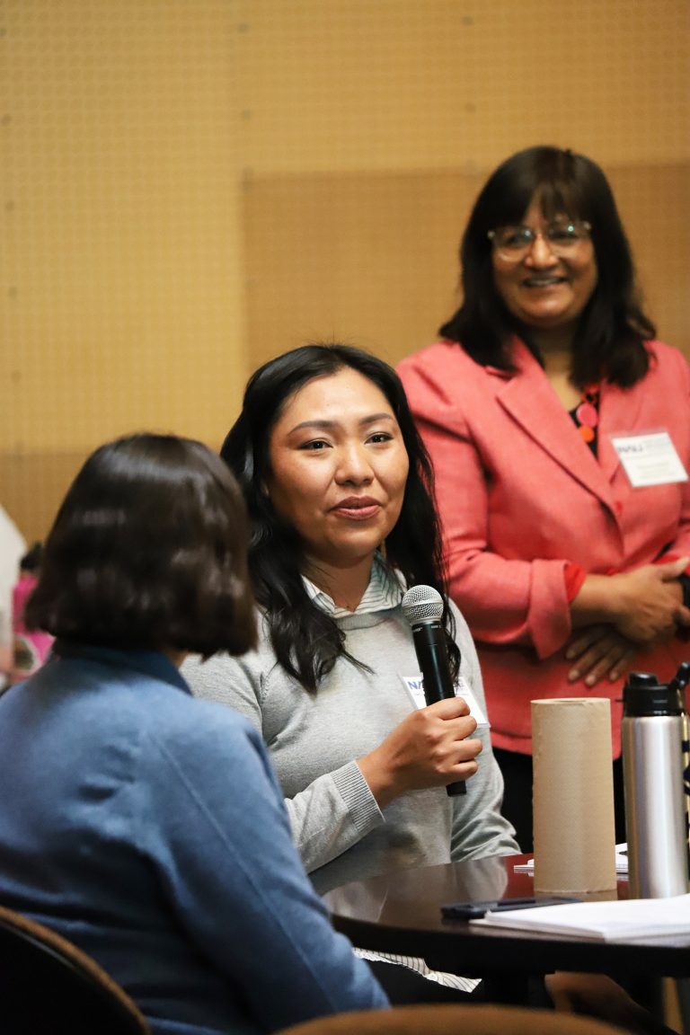 Melissa Wheeler talking into a microphone.