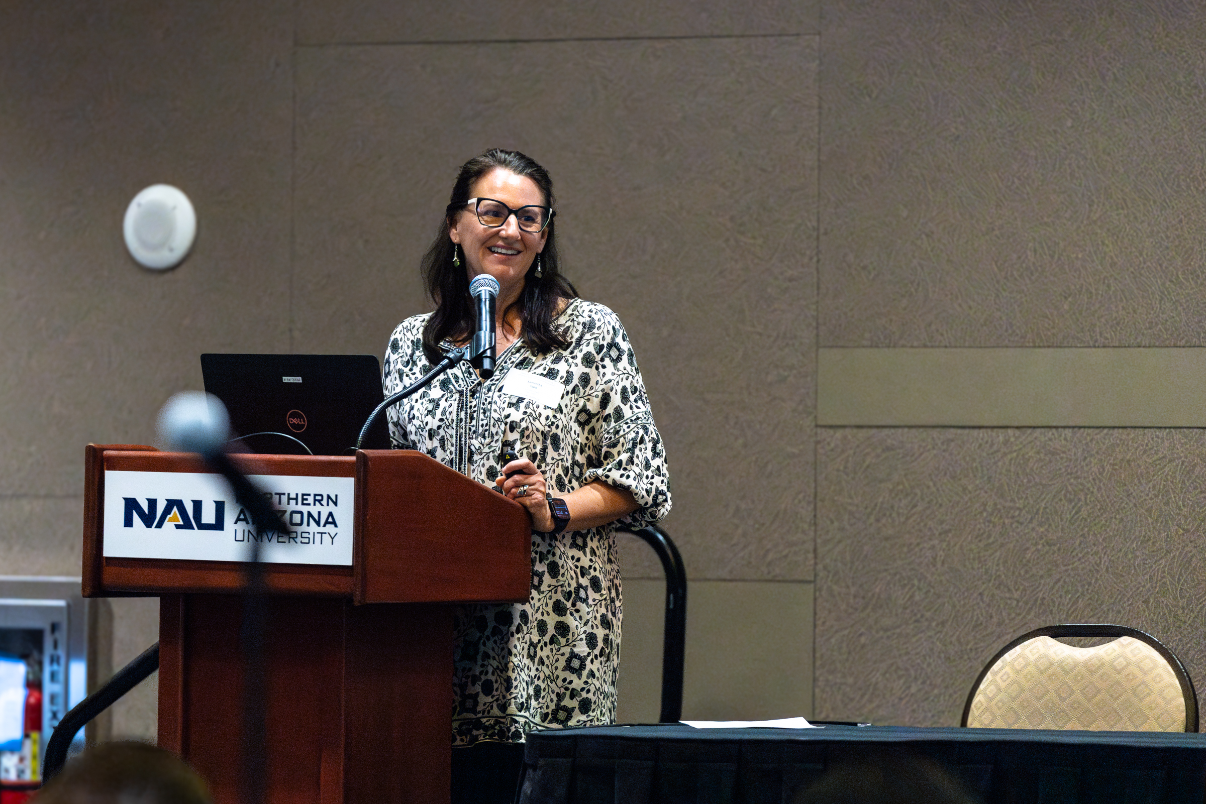 Samantha Sabo, CHER Associate Director and professor of health sciences, giving a speech at a podium.