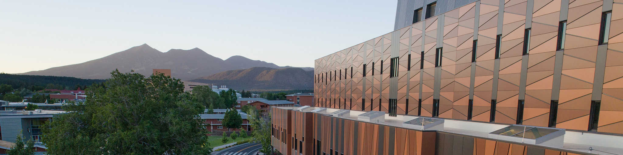 Student affairs building with peaks in background.