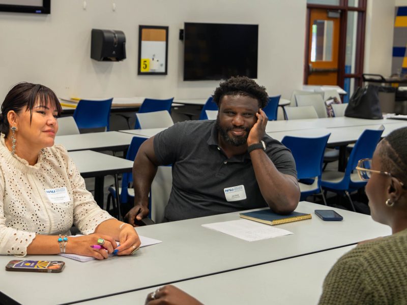 Simone Richardson and Job Elliott (left) speak to Kiera Butler (right) about research interest overlap.