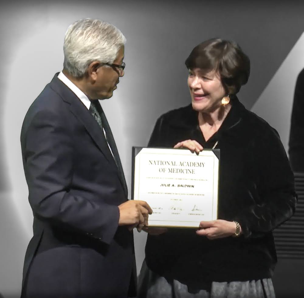 Julie Baldwin accepting her induction into the National Academy of Medicine from NAM President Victor J. Dzau.