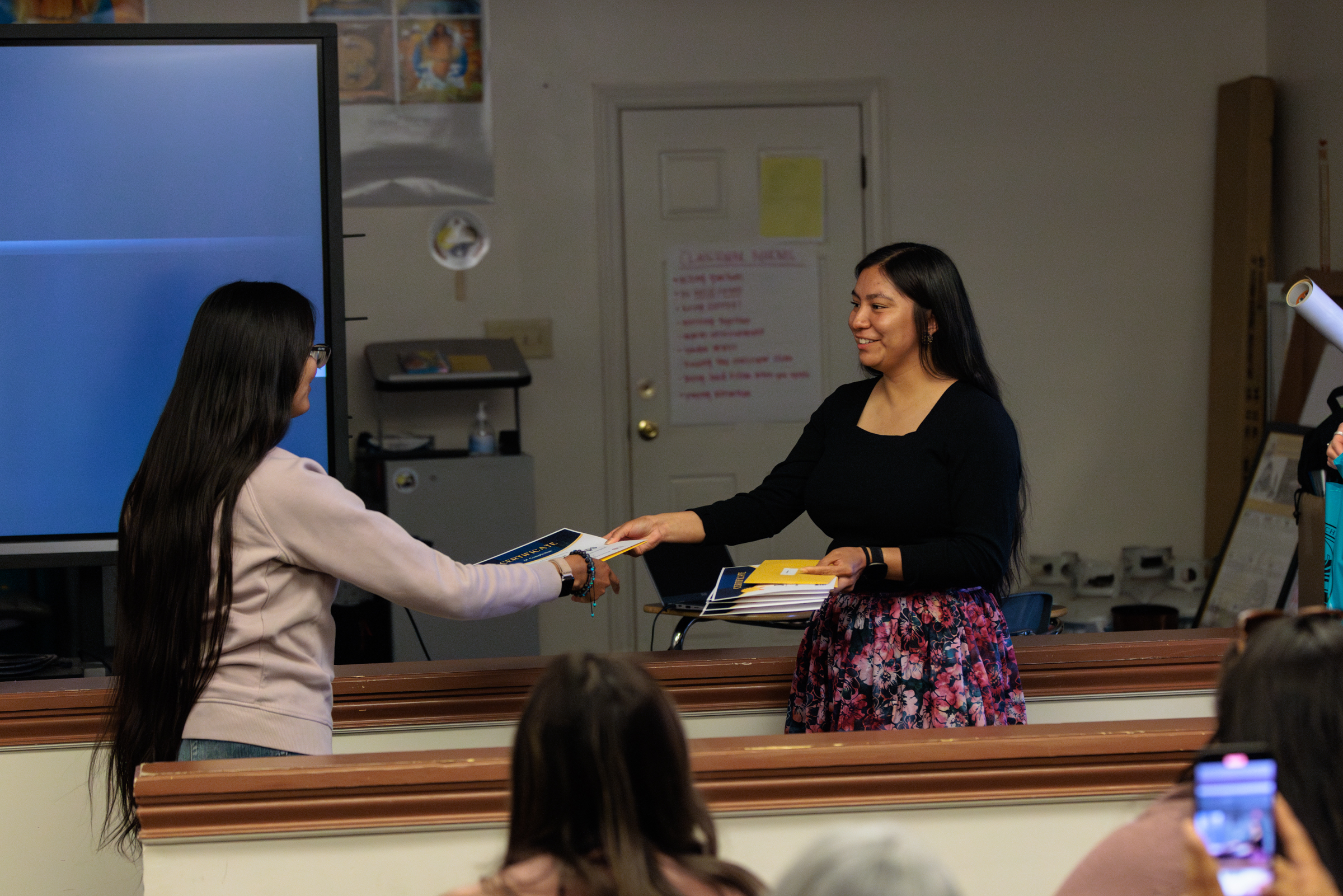 Tristina Phillips (left) received her graduation certificate for completing the program. 