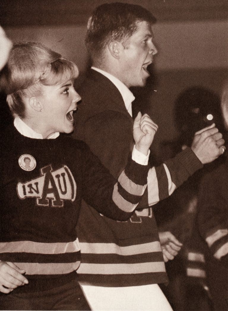 N A U's cheerleaders from 1967 wearing the Megaphone emblem on their uniforms.