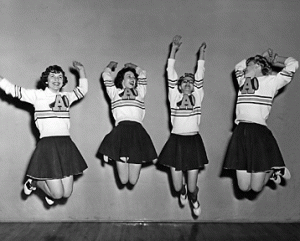 ASC Cheer Squad wearing uniforms featuring N A U's pre-1966 Megaphone symbol.