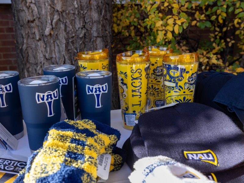 Merchandise with various N A U logos and Lumberjack symbols.